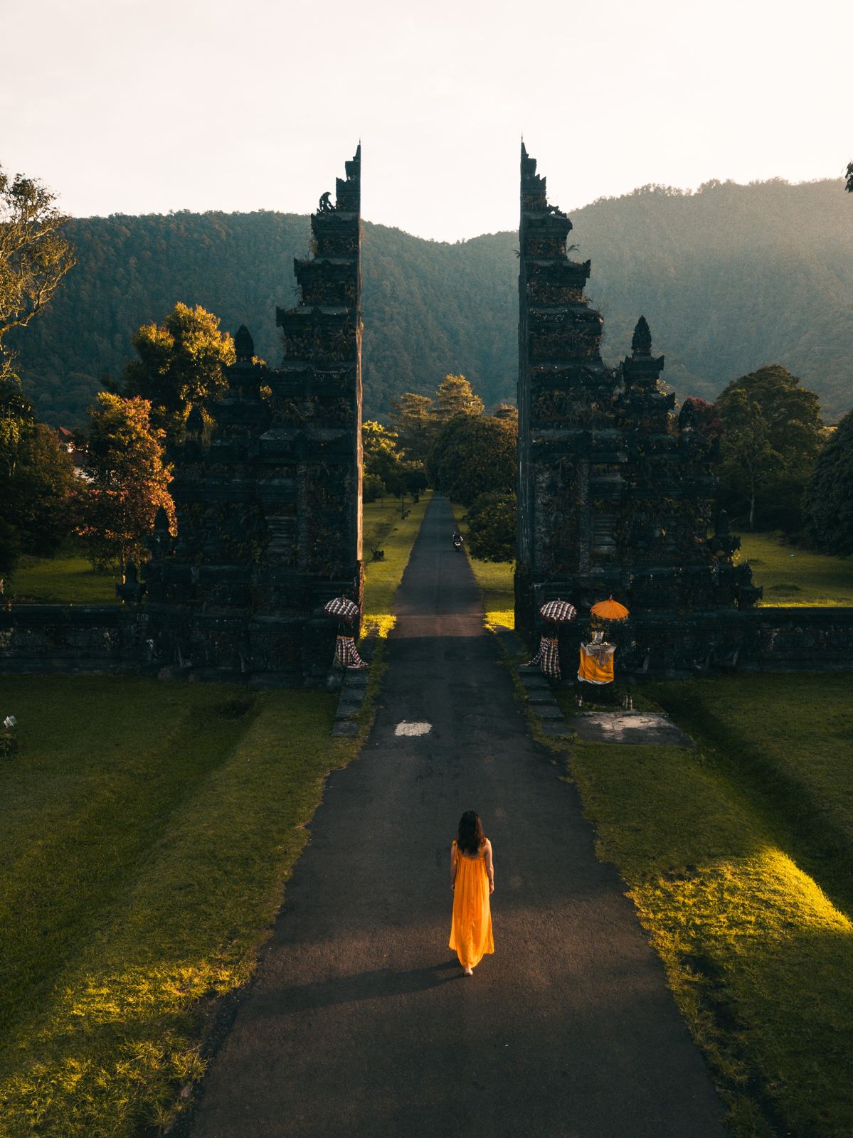 Traveller walking through a temple gate in Bali
